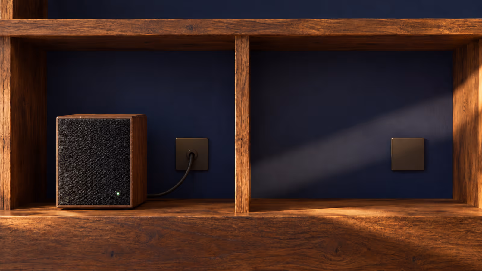A connected rectangular speaker remains in use beside an empty shelf compartment with a blank cable-access cover.